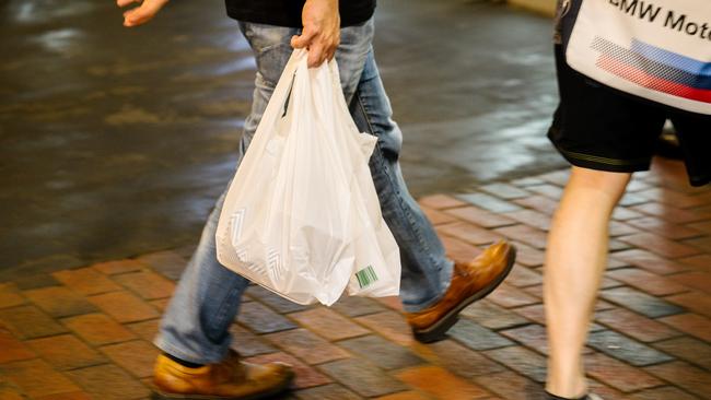 A shopper is seen walking with a plastic bag inside the Central Market in Adelaide, Friday, November 1, 2019. (AAP Image/Morgan Sette) NO ARCHIVING