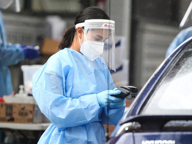 SYDNEY, AUSTRALIA - NewsWire Photos, DECEMBER 23 2021: Health professionals are seen working at the Haberfield Drive through Covid-19  testing clinic as testing demand surges ahead of the holidays in Sydney. Picture: NCA NewsWire / Gaye Gerard