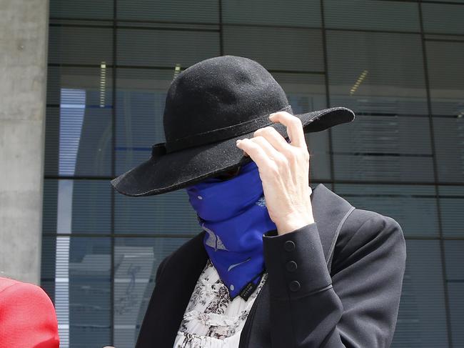 BRISBANE, AUSTRALIA - NewsWire Photos FEBRUARY 12, 2024: Karla Rosa Heath covers her face leaving the Supreme Court in Brisbane after she was given a suspended sentence for supplying a dangerous drug to a minor. Picture: NCA NewsWire/Tertius Pickard