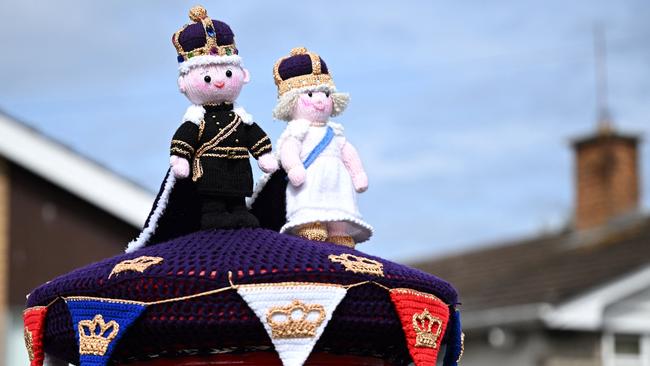 A knitted King Charles III and Camilla, Queen Consort displayed on a post office box next, in Rhyl, north Wales, ahead of the coronation ceremony. (Photo by Paul ELLIS / AFP)