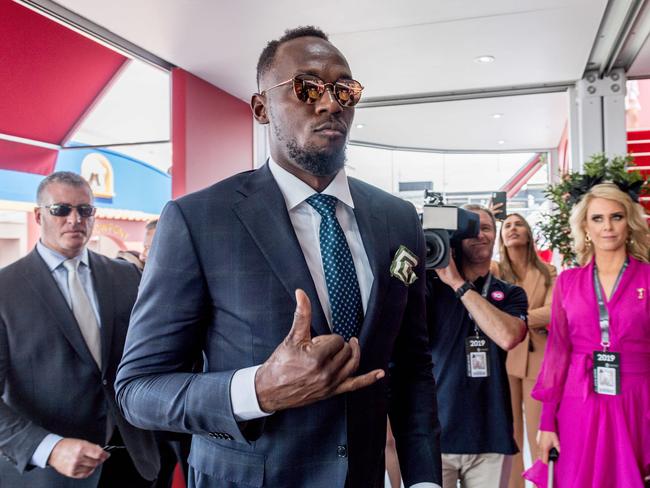 Usain Bolt arrives at the Mumm marquee in style. Picture: Jake Nowakowski