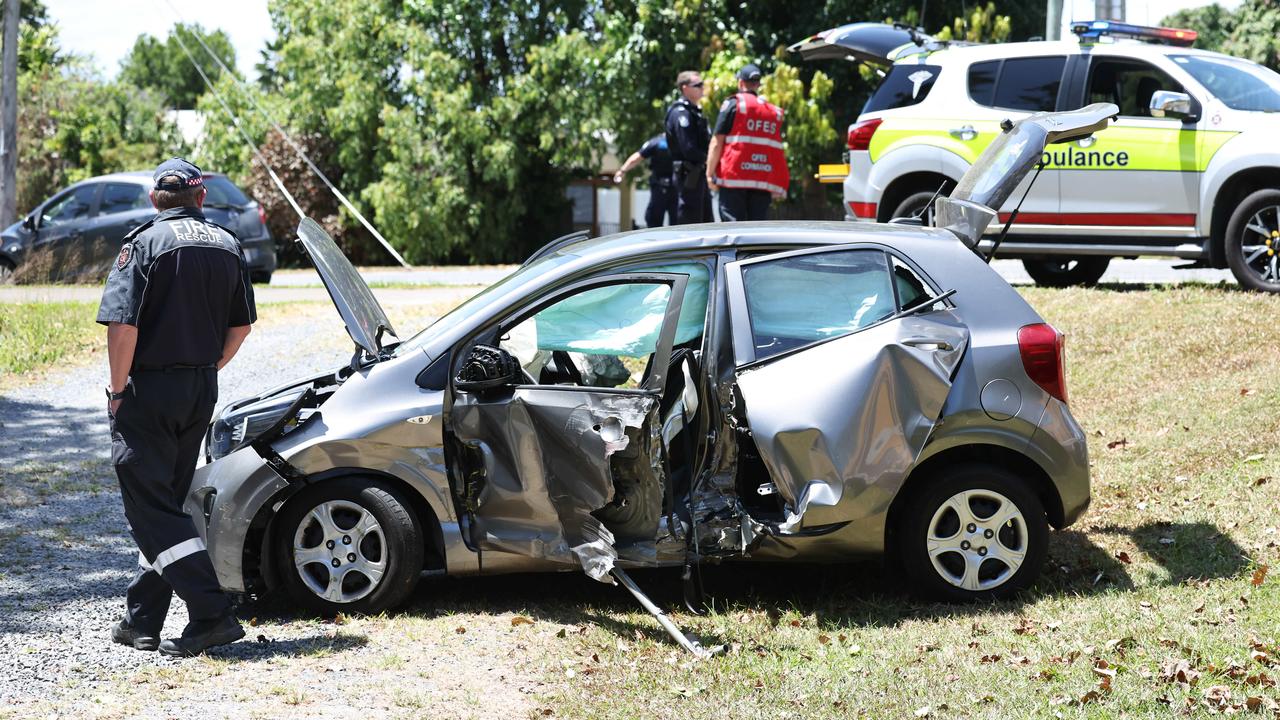 Emergency services personnel respond to a collision between a small car and a cane train at a level crossing on Beatrice Street, Mooroobool. Picture: Brendan Radke