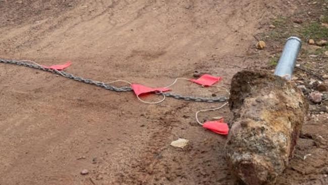 A damaged concrete bollard and chain at the Bare Creek Bike Park. Picture: Trail Care