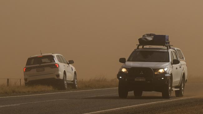 Cars - including our Ford Everest - were forced to pull over as the dust storm intensified. Picture: Mark Brake