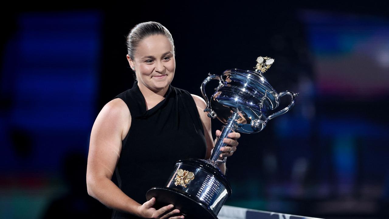 Retired former world number one Australian tennis player Ashleigh Barty carries the Daphne Akhurst Memorial Cup she won in 2022. Photo by Martin KEEP / AFP.