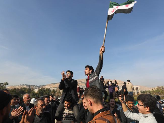 People in Damascus celebrate on December 9, 2024, after Islamist-led rebels declared that they have taken the Syrian capital. Picture: Bakr ALKASEM / AFP