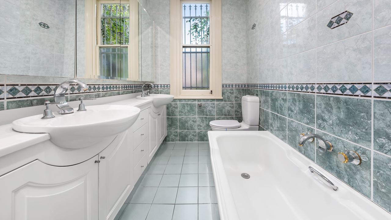 The bathrooms of the property feature floor-to-ceiling tiles and double basins.