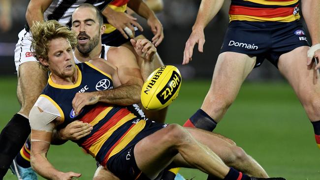 Rory Sloane is tackled by Steele Sidebottom during Friday night’s mauling at Adelaide Oval.