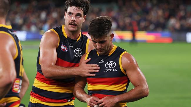 A shattered Josh Rachele (right) is consoled by Crows teammate Darcy Fogarty after the Round 6 loss to Essendon at Adelaide Oval. Picture: James Elsby