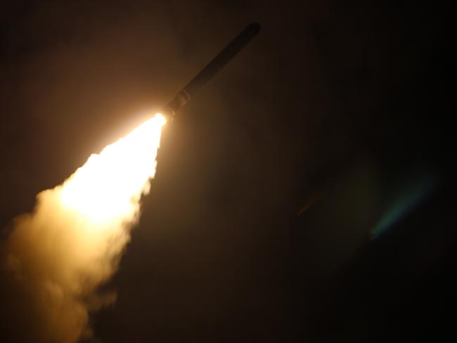 The  USS Monterey fires a Tomahawk land attack missile as part of the assault on Syria.