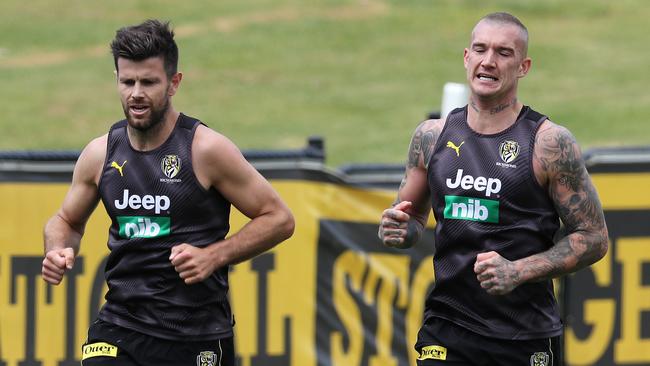 Dustin Martin pushes Trent Cotchin on a lap of Punt Rd. Picture: Michael Klein