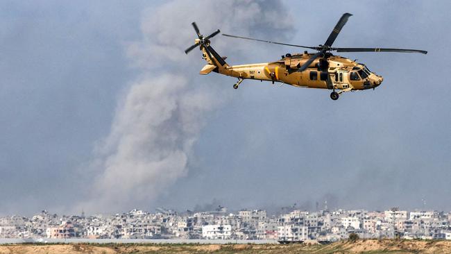 A Black Hawk military transport helicopter shown flying near the border with the Palestinian territory amid continuing battles between Israel and the militant group Hamas. Picture: Jack Guez / AFP