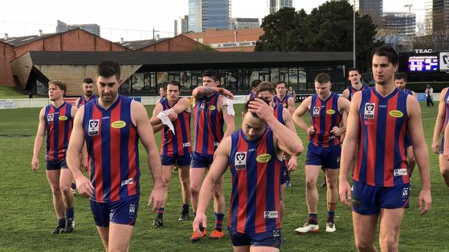 Disappointed Port players come from the ground.