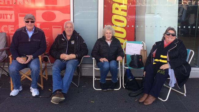 Left to right: Alan Kingston, Graham Cox, Carole Fanshaw and Brenda Cox line up in Camberwell for AFL Grand Final tickets. Picture: Ellen Cumming.