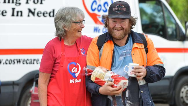 STAFF OF LIFE: Glen Barnes , of Elizabeth Park, receives food from Cos We Care founder Ann Cooper at Fremont Park yesterday. Picture: BRENTON EDWARDS/AAP.