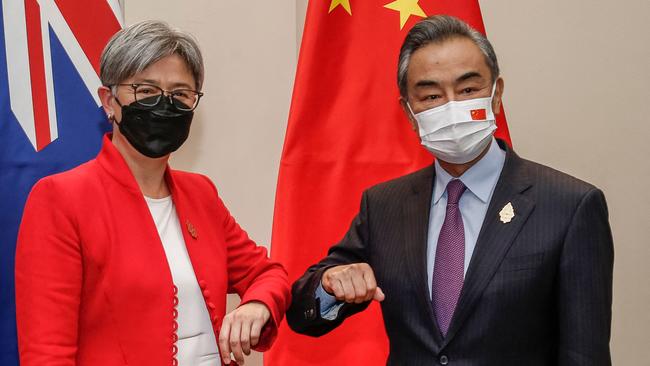 Foreign Minister Penny Wong, left, bumps elbows with China's Foreign Minister Wang Yi during their bilateral meeting on the sidelines of G2. Picture: AFP