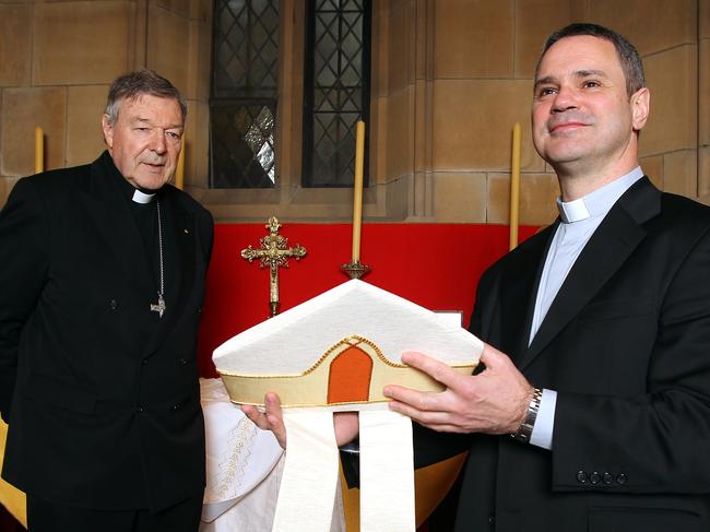 Cardinal George Pell (L), who ordained Father Peter Comensoli as an auxiliary bishop, pictured at St Mary's Cathedral in Sydney.