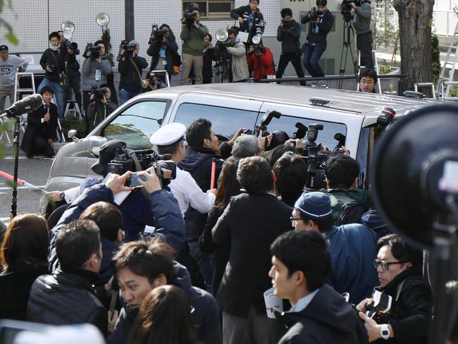 Photographers surround a police van transporting Takahiro Shiraishi, whose gruesome deeds both repel and fascinate the Japanese public. Picture: AFP.