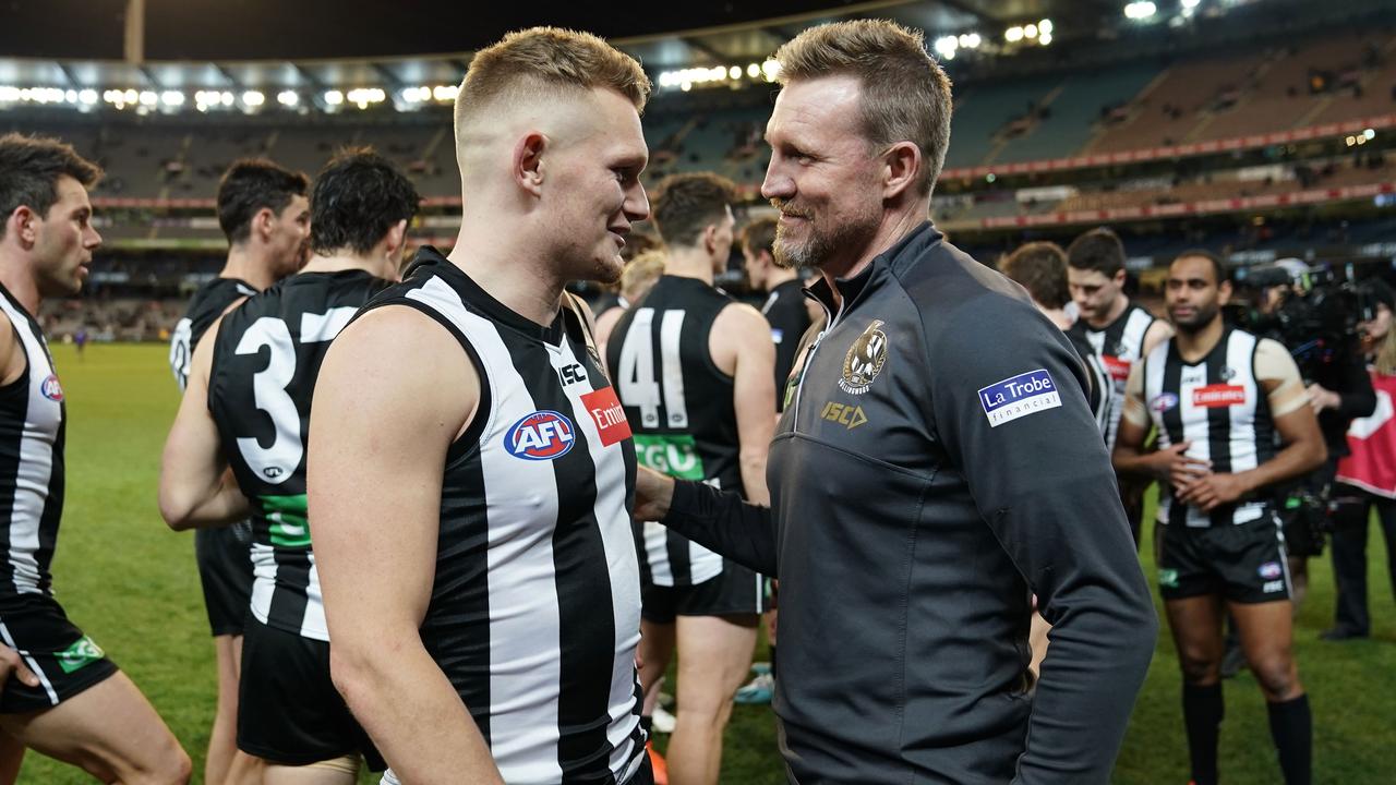 Adam Treloar with Magpies coach Nathan Buckley.