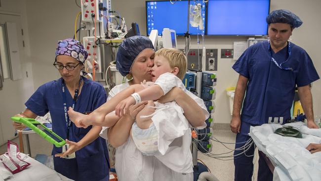 Harry is carried by mum Simone. Picture: Jason Edwards