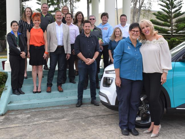 In front of the car is Icon Cancer Centre palliative care nurse Rosie Stannard and Trudy Crowley Foundation board member Jacqui Camilleri. On the front rows of the steps (from left) are ATSICHS finance manager Dr Maria Tyler, Mackay Community Foundation (MCF) board member Jody Euler, MCF board member Nick Bennett, Selectability Mackay general manager Chris Attard, Selectability Mackay's Debra Bur