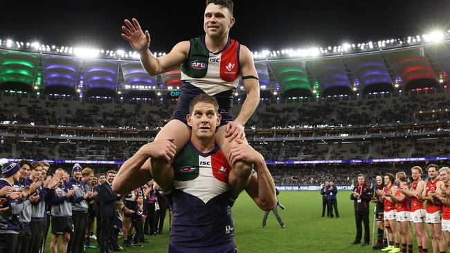 Essendon players clap Hayden Ballantyne and Aaron Sandilands after their final AFL game.