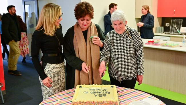 Former employee Meryl Hudson who remembered the agreement cut the cake to celebrate the good news. Picture: St Giles