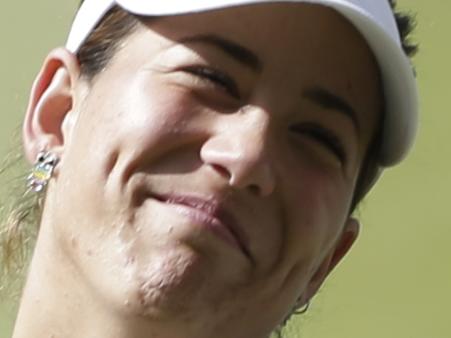 Garbine Muguruza of Spain holds the runner up trophy during the trophy ceremony after losing to Serena Williams of the United States, at the All England Lawn Tennis Championships in Wimbledon, London, Saturday July 11, 2015. (AP Photo/Pavel Golovkin)