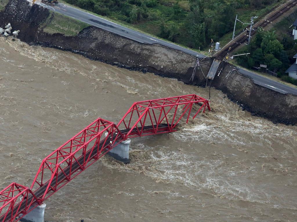 This aerial view shows a damaged train bridge over the swollen Chikuma river in the aftermath of Typhoon Hagibis in Ueda, Nagano Japa. Picture: AFP/Japan OUT