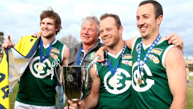 Greensborough coach Robert Hyde celebrates with co-captains Tim Bongetti, Matt Hyde and Lachlan McQuillan. Picture: Mark Dadswell