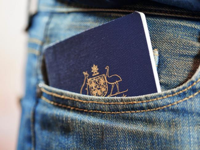 ESCAPE: Australian passport in mans jeans pocket, close up. Picture: Istock