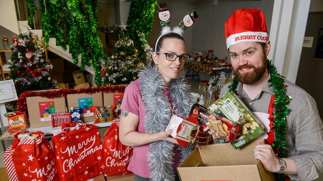 Astra Fleetwood and Ben Falcon from Anglicare SA packing Christmas hampers. Picture: NCA NewsWire / Brenton Edwards