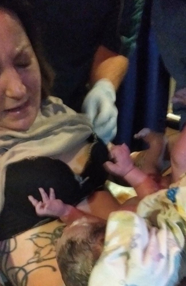 Emma Jones cuddles her newborn baby Phoenix moments after he is born on a Moreton Bay water ambulance. Picture: Contributed