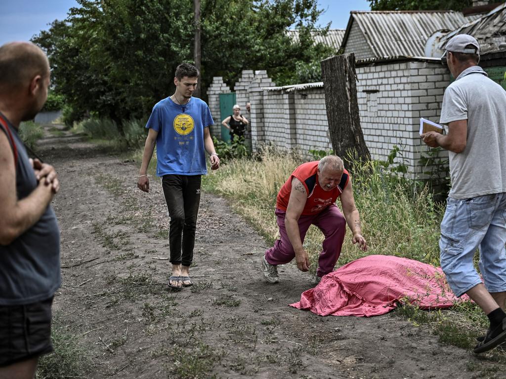 A man approaches the body of his son who was killed by a cluster rocket in the city of Lysychansk in the eastern Ukrainian region of Donbas. Picture: AFP