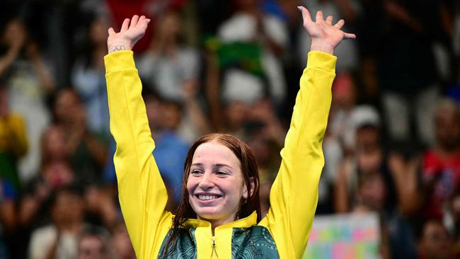 TOPSHOT - Gold medallist  Australia's Mollie O'callaghan celebrates on the podium after the women's 200m freestyle swimming event during the Paris 2024 Olympic Games at the Paris La Defense Arena in Nanterre, west of Paris, on July 29, 2024. (Photo by FranÃ§ois-Xavier MARIT / AFP)
