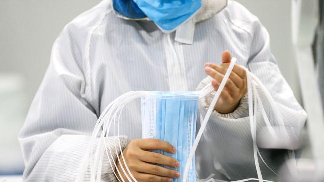 A worker produces face masks at a factory in Qingdao in China’s eastern Shandong province. Picture: AFP