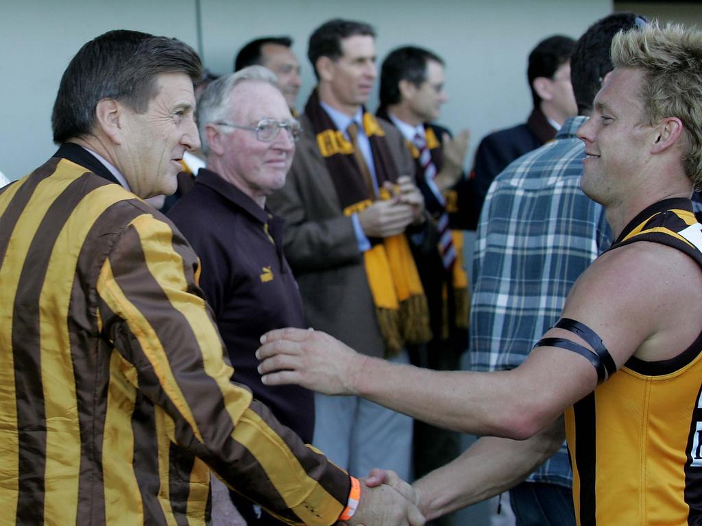 Jeff Kennett shakes hands with Mitchell during his playing days.