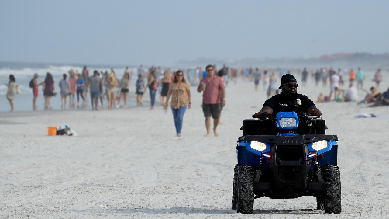 Police drive down Jacksonville Beach to enforce Florida’s rules for what activities can take place. Picture: Sam Greenwood/Getty Images