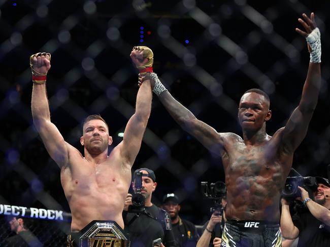 PERTH, AUSTRALIA - AUGUST 18: Dricus Du Plessis of South Africa has his arm raised by Israel Adesanya of Nigeria after winning the Middleweight championship fight by submission during UFC 305 at RAC Arena on August 18, 2024 in Perth, Australia. (Photo by Paul Kane/Getty Images)