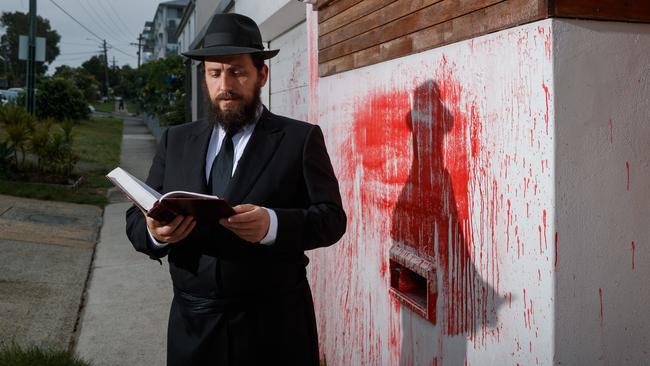 Rabbi Shmueli Feldman prays outside the former home of Alex Ryvchin in Sydney’s east that was the subject of an anti-Semitic attack. Picture: Max Mason-Hubers