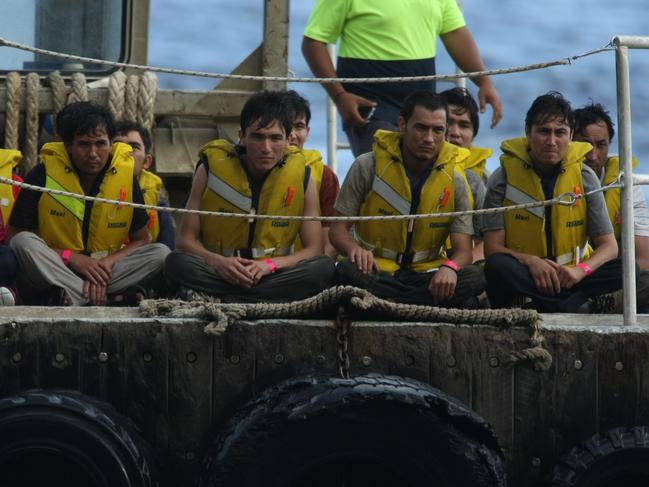 People smuggler Younos Yari is seated in the front row, furthest on the right.ORIGINAL CAPTION: 19-08-2010. Asylum seekers from HMAS Wollongong on barge to CI Jetty at Flying Fish Cove, Christmas Island, to board buses to go to detention centres.