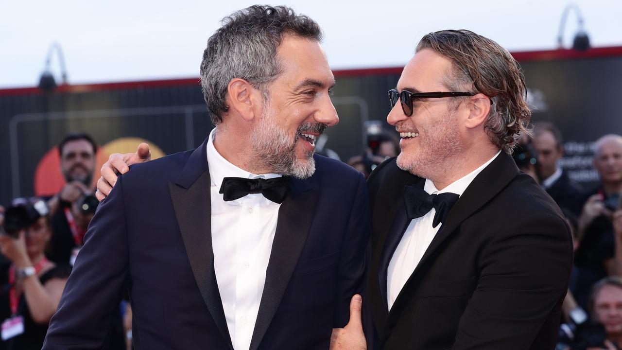 Joaquin Phoenix and Director Todd Phillips walk the red carpet ahead of the screening. Picture: Getty.