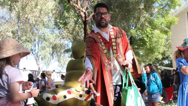 Alice Springs Town Council Mayor Matt Paterson was one of many marchers throwing lollies into the crowd. Picture: Gera Kazakov
