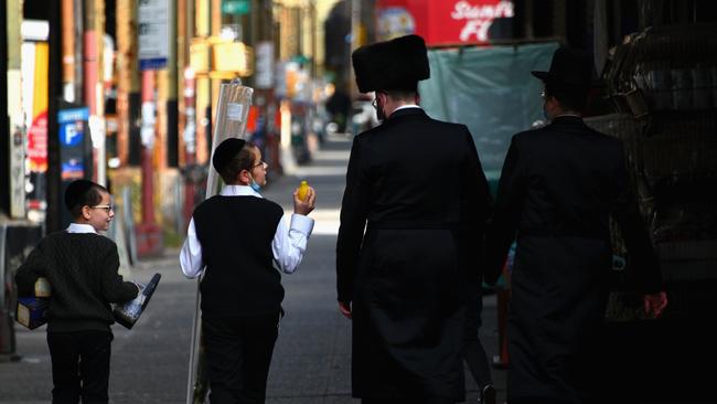 Orthodox Jews walkthrough the Borough Park section of Brooklyn, New York. Picture: AP