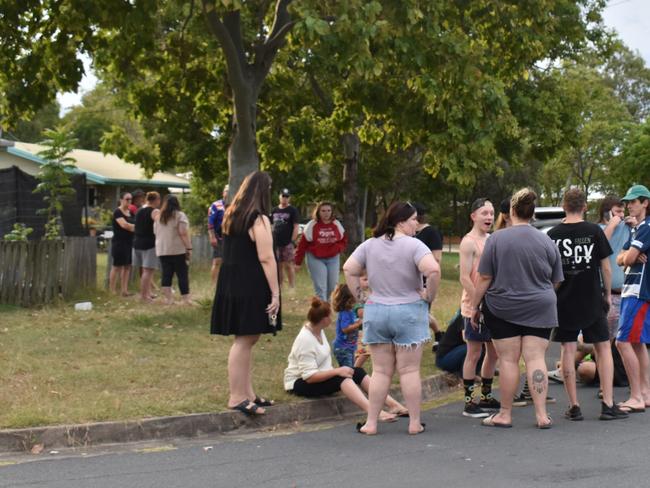 The final crowd at an address in Norman Gardens before they were ordered to move on by police.