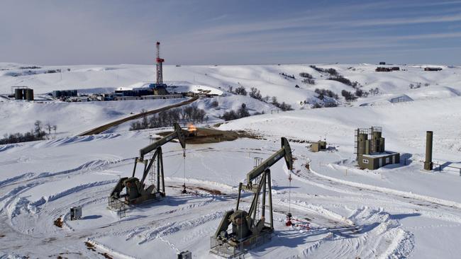 Pumpjacks operate as a drill rig sits on a well pad in the Bakken Formation in Williston, North Dakota. Picture: Bloomberg