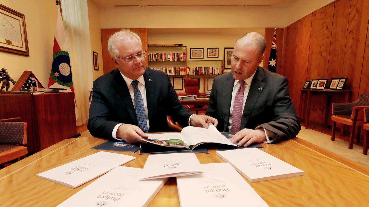 Prime Minister Scott Morrison with Treasurer Josh Frydenberg looking over the Budget papers. Picture: Adam Taylor