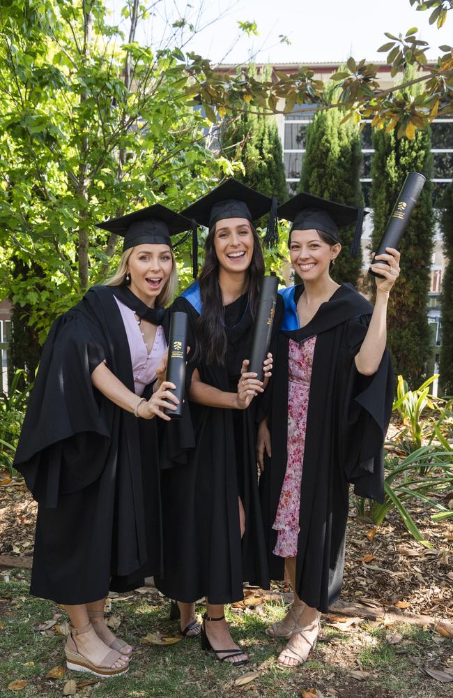 Bachelor of Nursing graduates (from left) Shenoa Trahair, Monique Crilly and Kate Osborne celebrate at a UniSQ graduation ceremony at Empire Theatres, Tuesday, October 31, 2023. Picture: Kevin Farmer