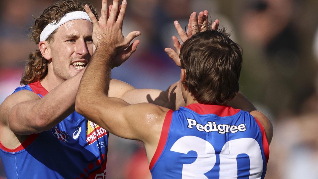 Aaron Naughton (left) celebrates a goal against the Gold Coast Suns. Picture: Martin Keep/Getty Images