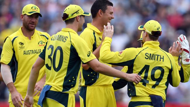 Australia's Josh Hazlewood (C) celebrates with teammates.